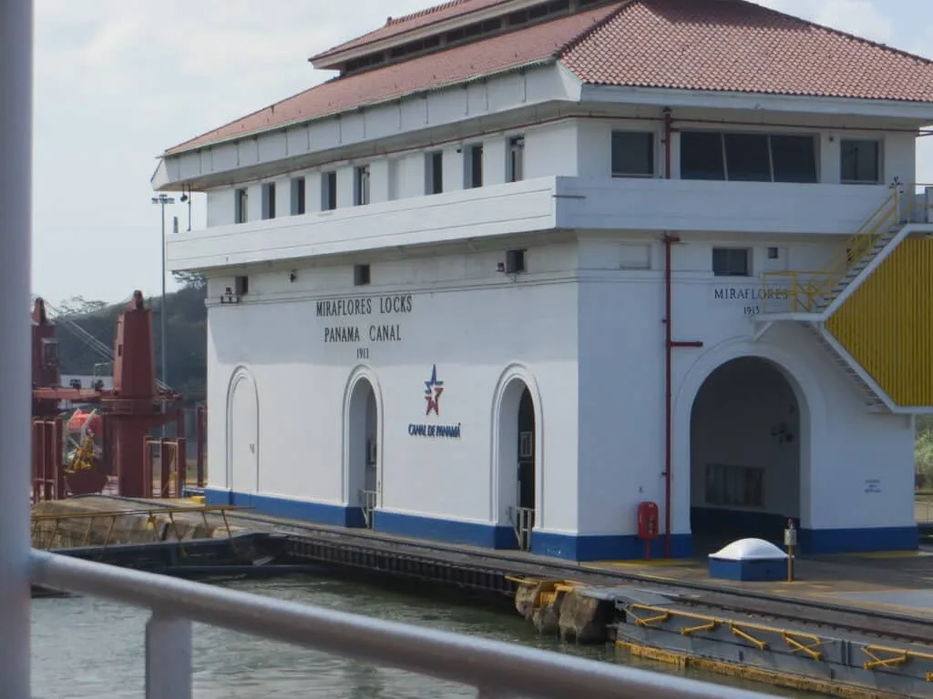 Miraflores Lock - a white building on a canal ensures ships transit safely.