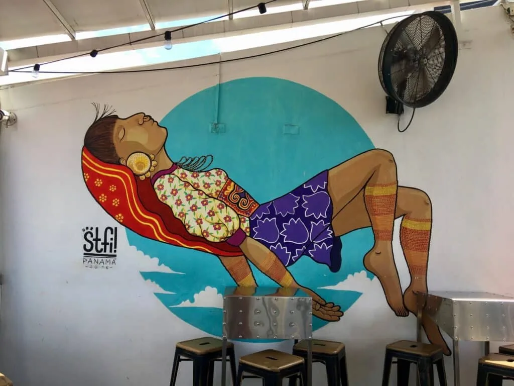 Freso of a woman lounging on a chair and having a siesta.