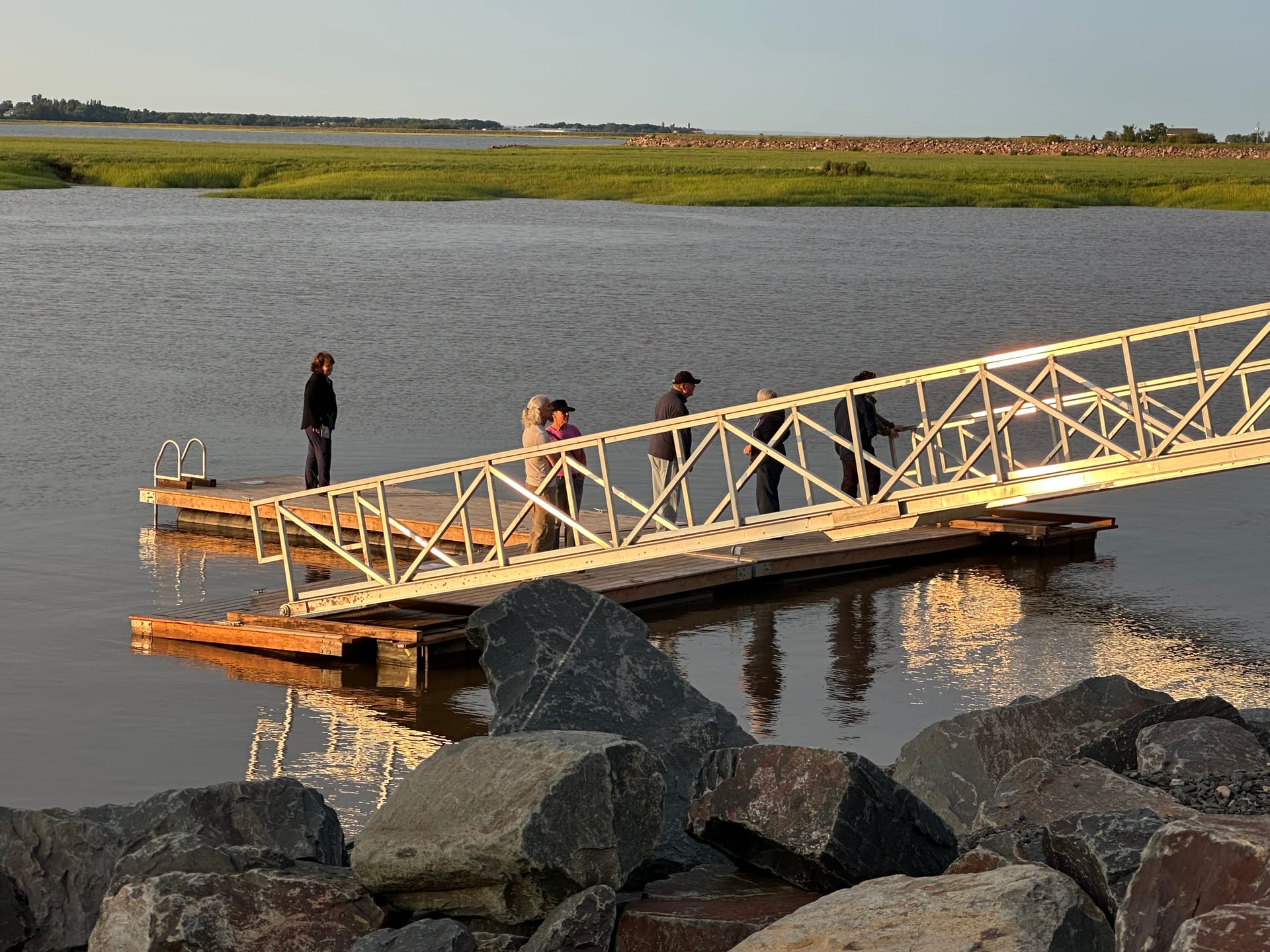 People on the tidal dock watching the water levels in Wolfville
