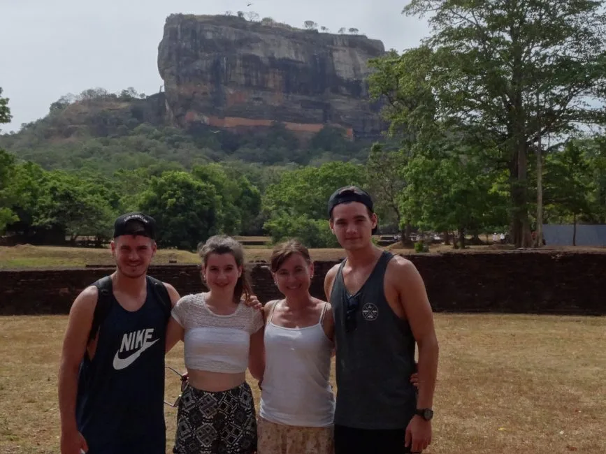 Tourists stand in front of Sigiriya Lion Rock which is a popular destination in Sri Lanka. It’s a world heritage site.