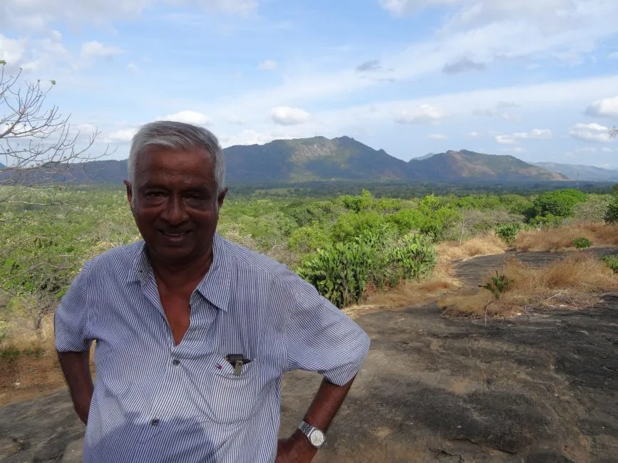 Man standing in Dambulla with mountain views behind
