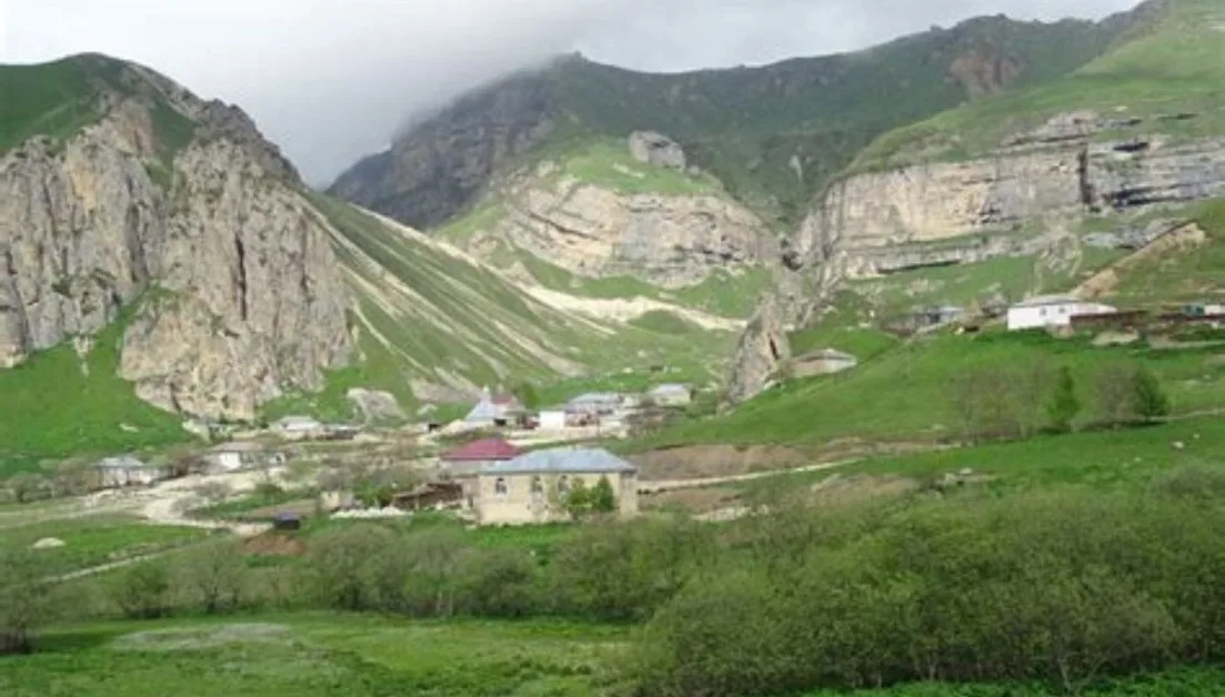 Typical Azerbaijani mountain villages are remote and are set at the edge of steep cliffs. Here several homes sit in a valley at the foot of mountains.