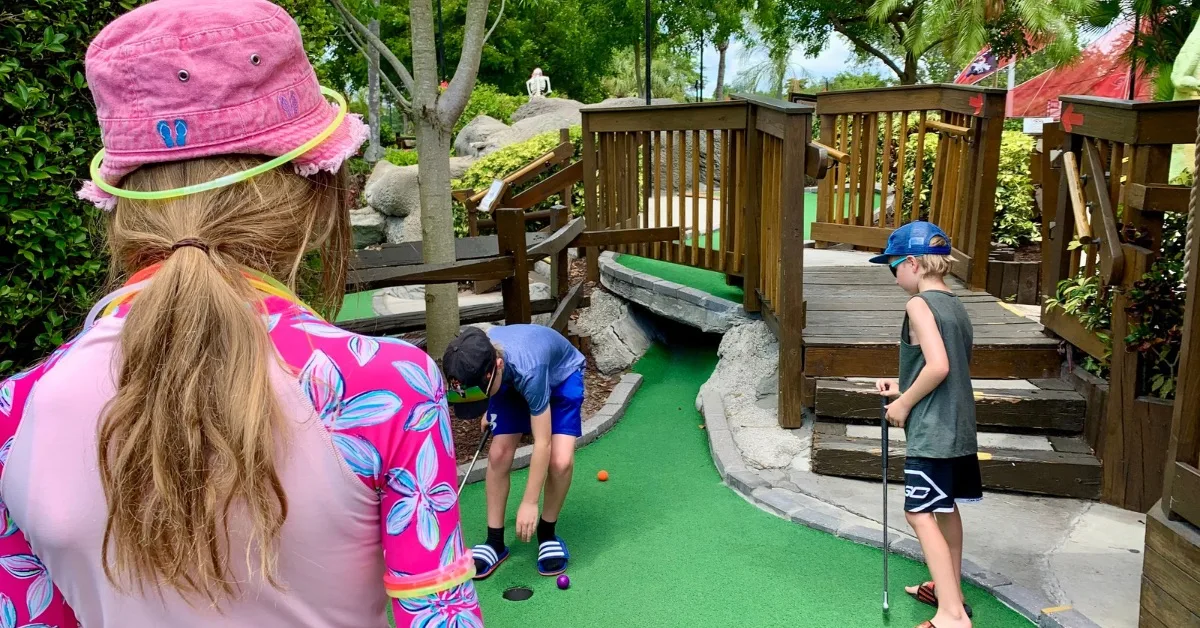 Kids playing mini golf.