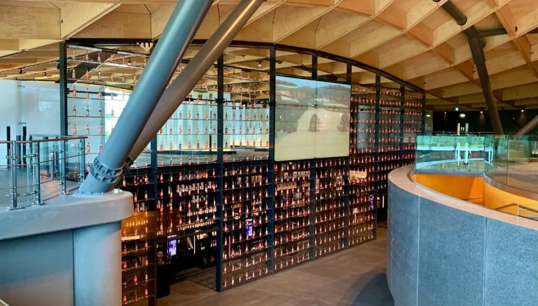 A glass case displays prize Scottish whisky for visitors to view. Macallan’s is one of the most popular visitors stops on a Scotland road trip.