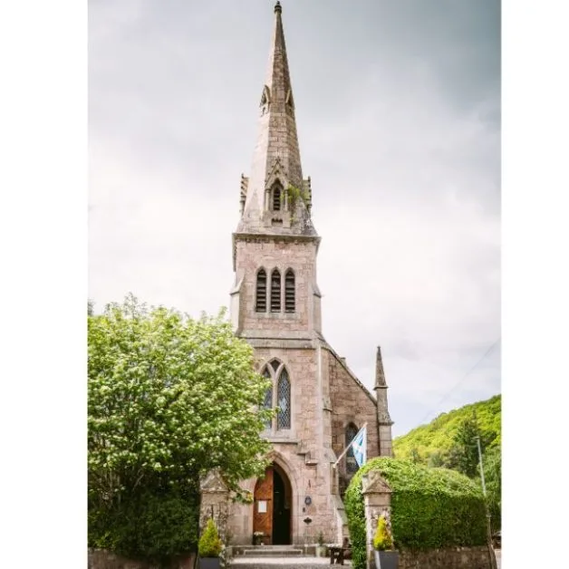 A traditional Scottish church or 'Kirk' made of stone with a high steeple. Now converted into a business.