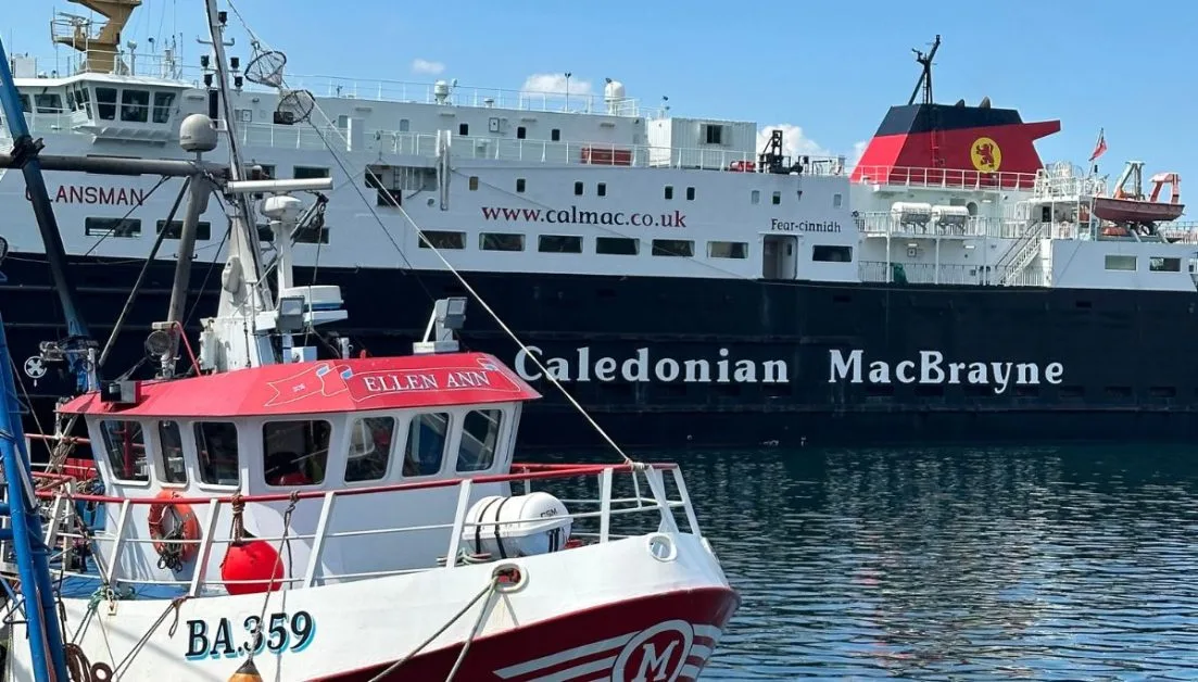 Fishing Boat and Passenger Ferry moored at Oban in Scotland.