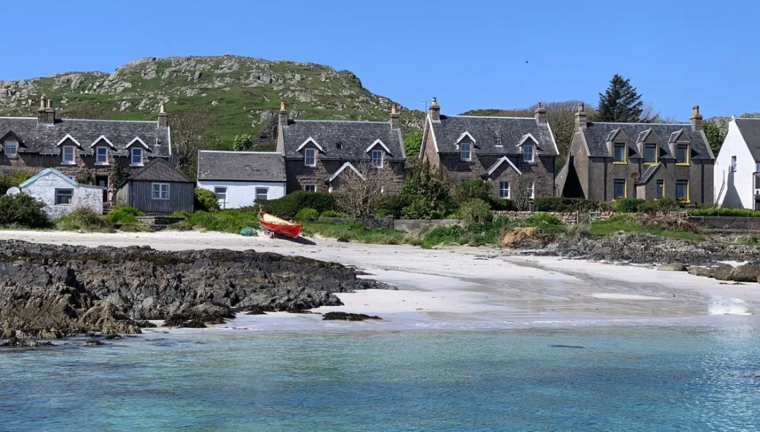 Beach and granite traditional houses on the Isle of Iona Scotland.