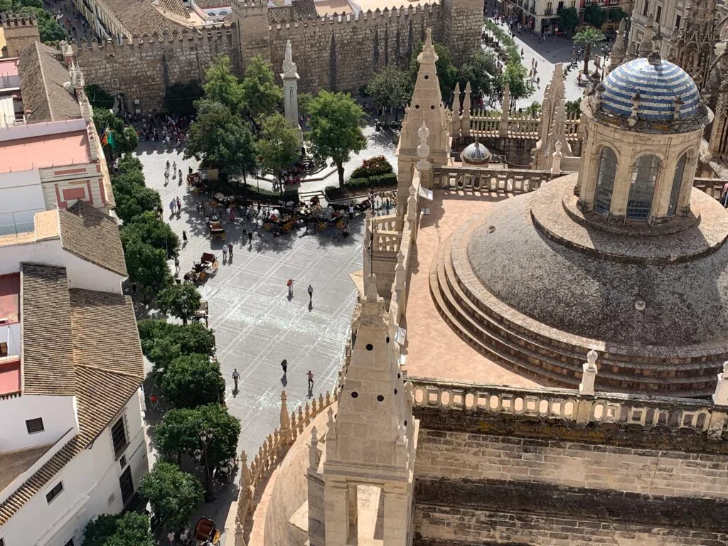 Sitting at a rooftop bar in Seville there are views over rooftops, palace domes and streets.