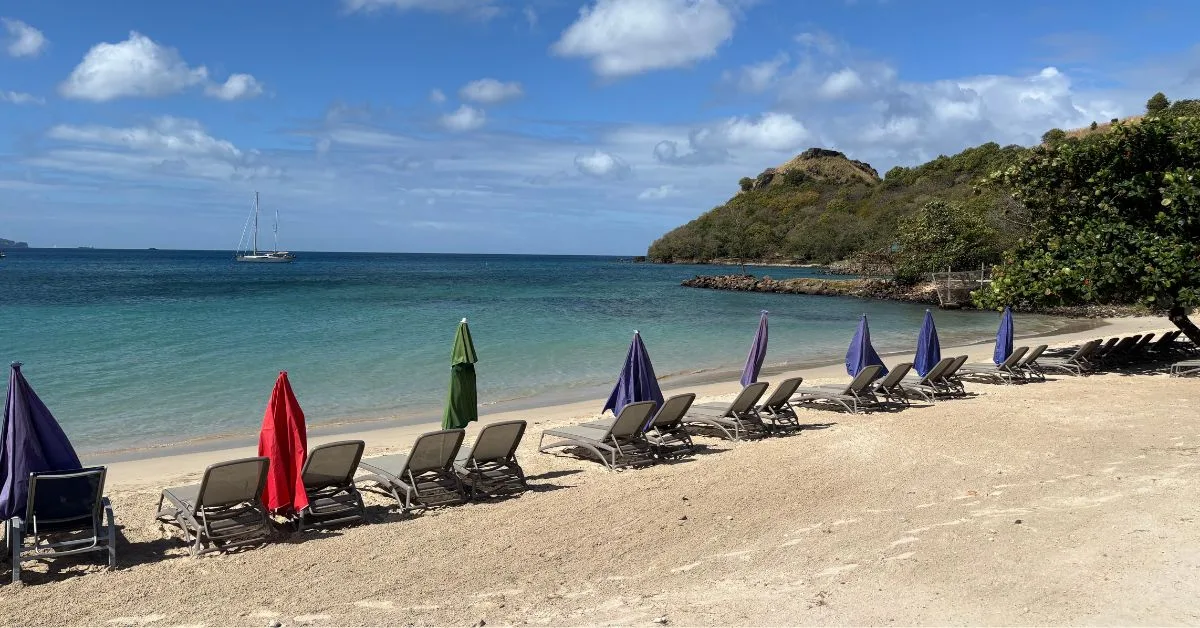 Rows of sun loungers lined up along the beach which is quiet - no one on there