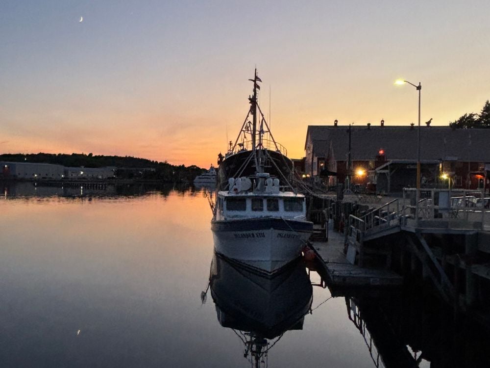 Sunset over the harbour with a boat in Lunenburg