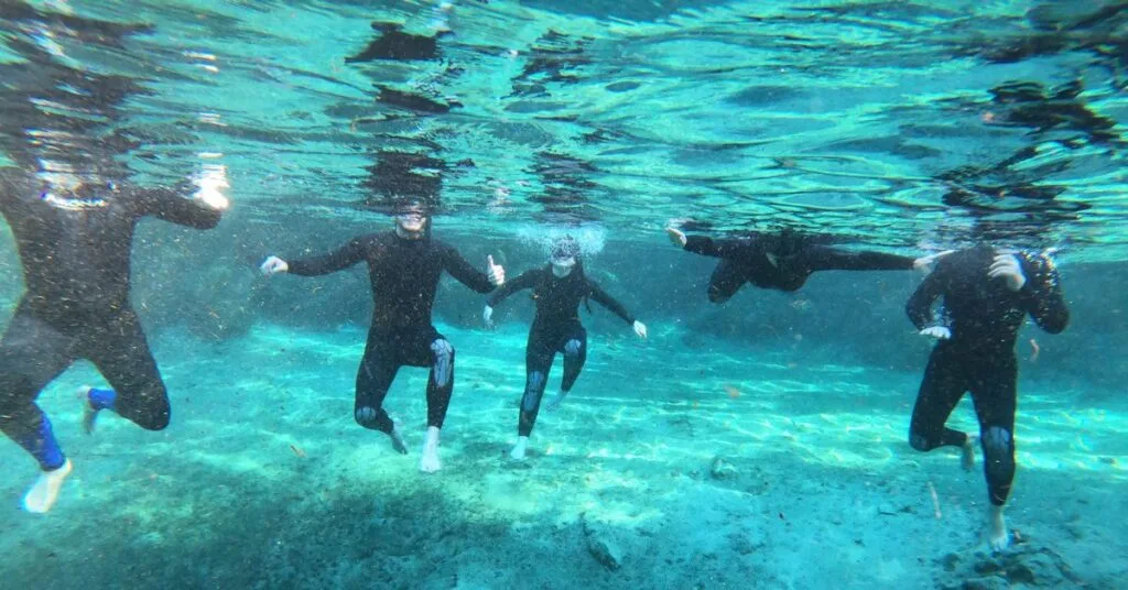 Swimming in clear waters of Three Sisters Spring.