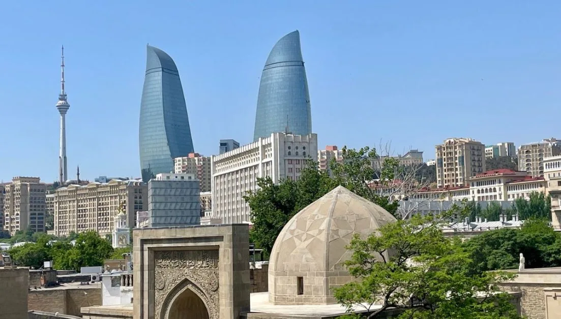 Baku City Skyline with glass Flame Towers and ancient walled city.