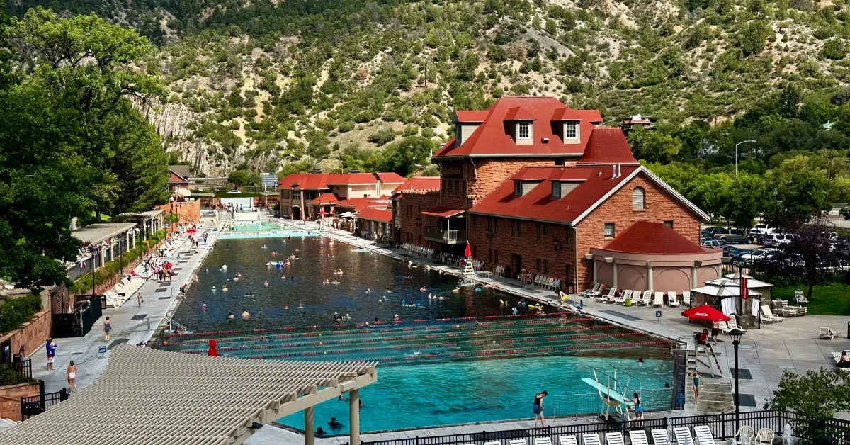 A large pool with bathers fed by hot mineral springs in Glenwood Springs.