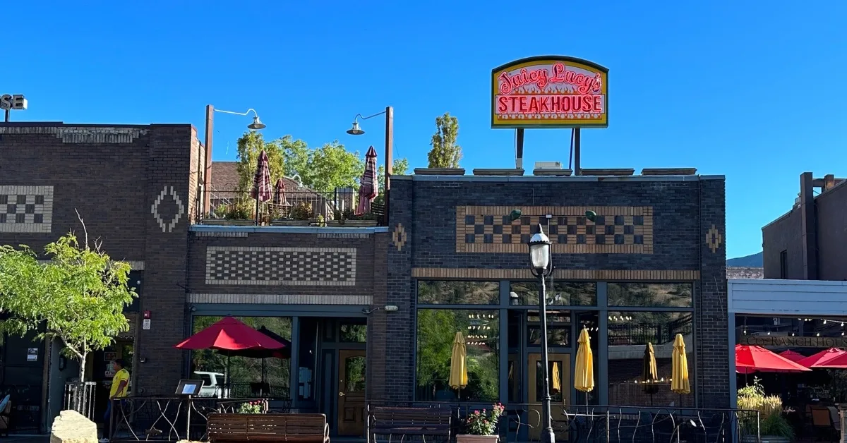 Street with  restaurants and roof top area called Juicy Lucy’s in Glenwood Springs Colorado.