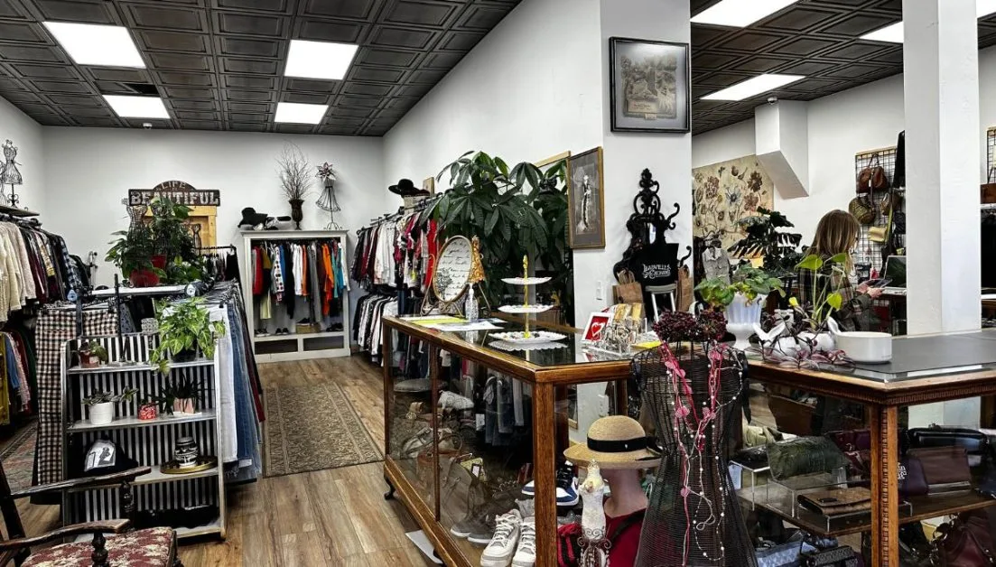 Boutique store displaying clothes, jewelry and other accessories like hats.