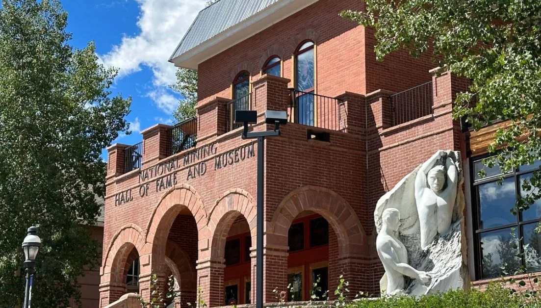 A brown brick building with arched entrance houses the National Mining Hall of Fame and Museum in Leadville.