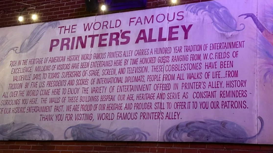 A wall sign describing the history of Printer’s Alley in Nashville.