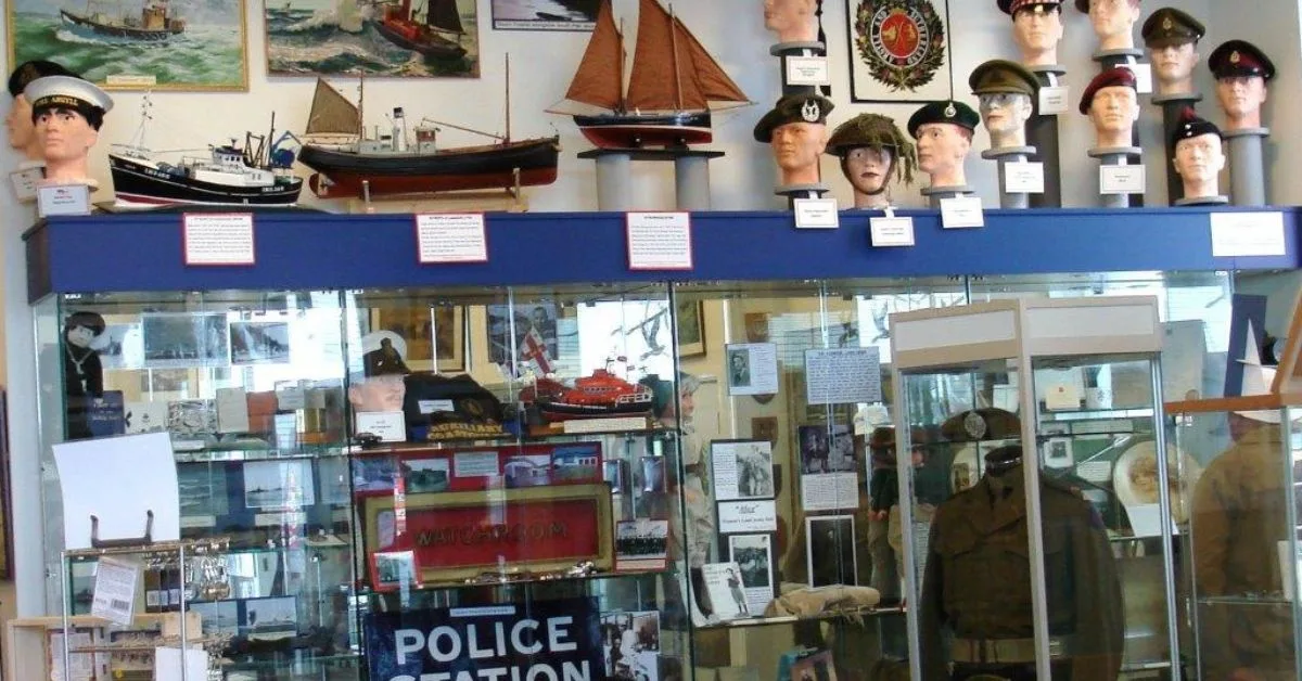 Minature ships, naval caps and other local history artifacts in a museum in Oban.