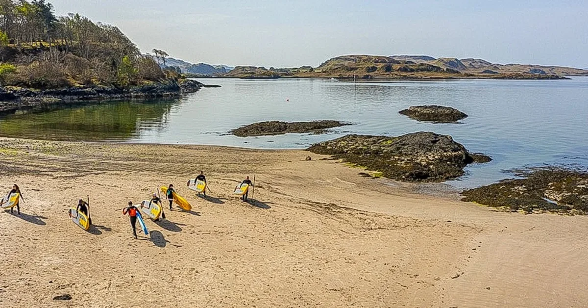Ganavan Sands near Oban where people are heading out to the bay to paddleboard.