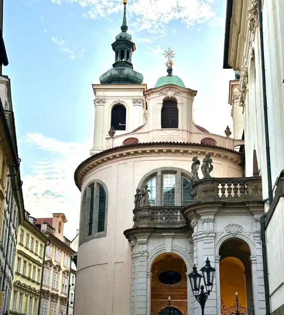 A round tower with dome roof sections is a church. It is located in Old Town Prague a popular place to visit.