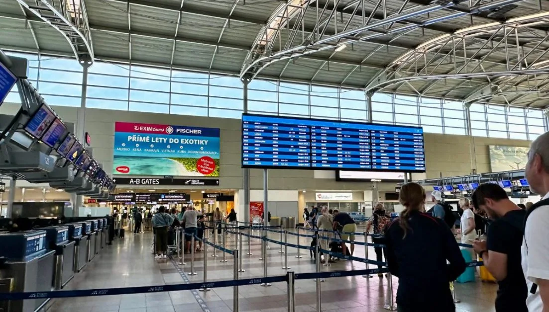 Prague Airport's Main departure lounge with flight information displayed.