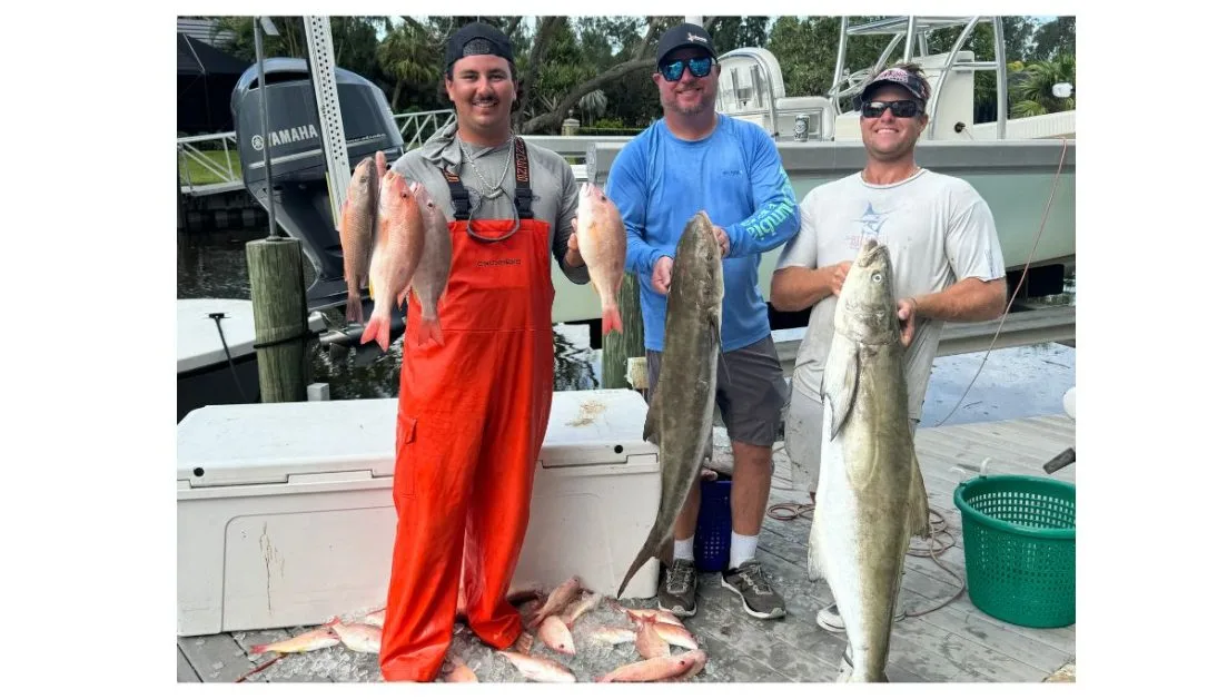 Captain Michael Russo and two clients show large fish catch from a charter trip in Sarasota.
