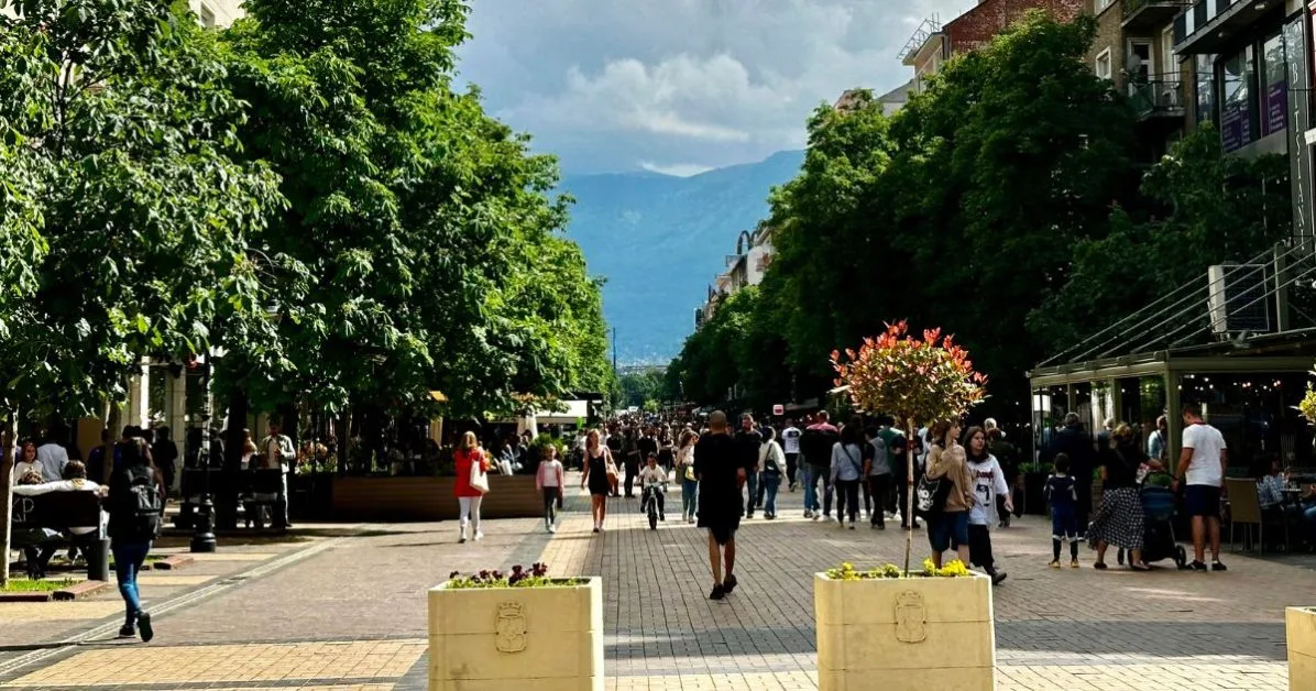 Main pedestrian street in Sofia with a view of Vitosha Mountain from the city. Trees line both sides of the avenue.