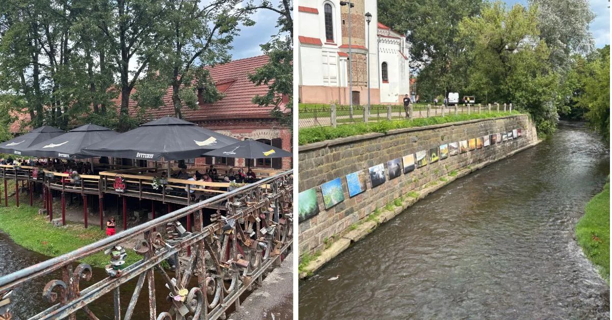 Bridge with raised cafe on stilts next to water; a selection of paintings are hung up on the brick wall by the river