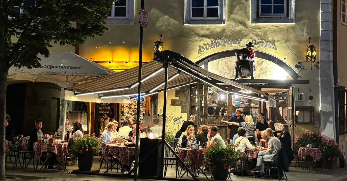 People sitting outside in a cafe in the evening