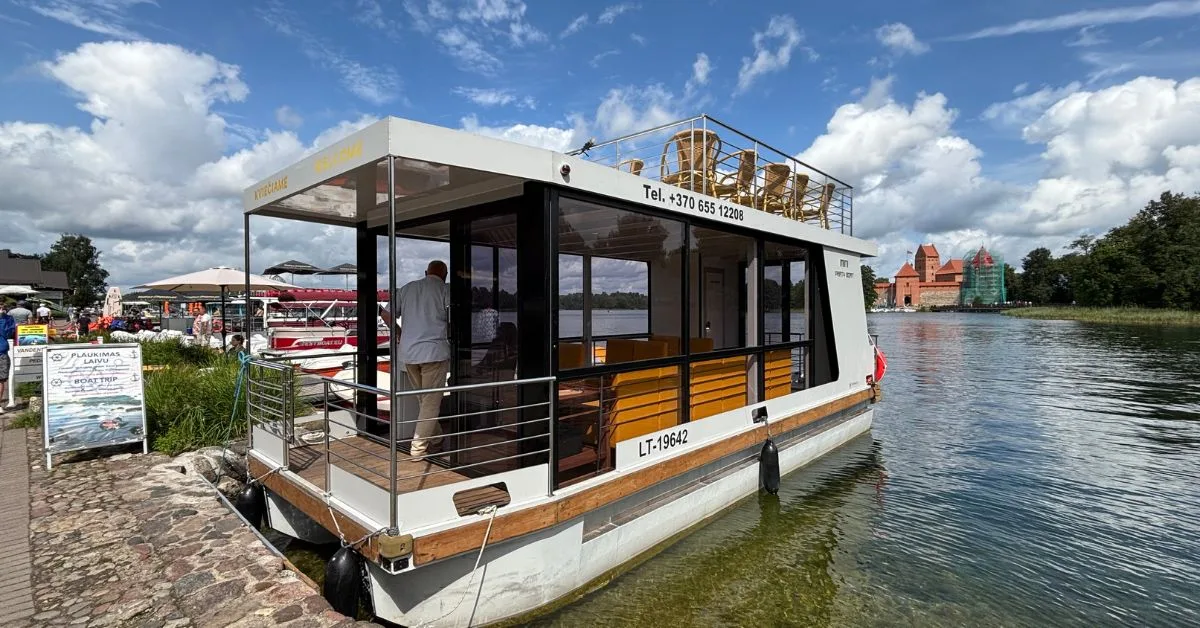 Tour boat moored up on shores in Trakai Lake