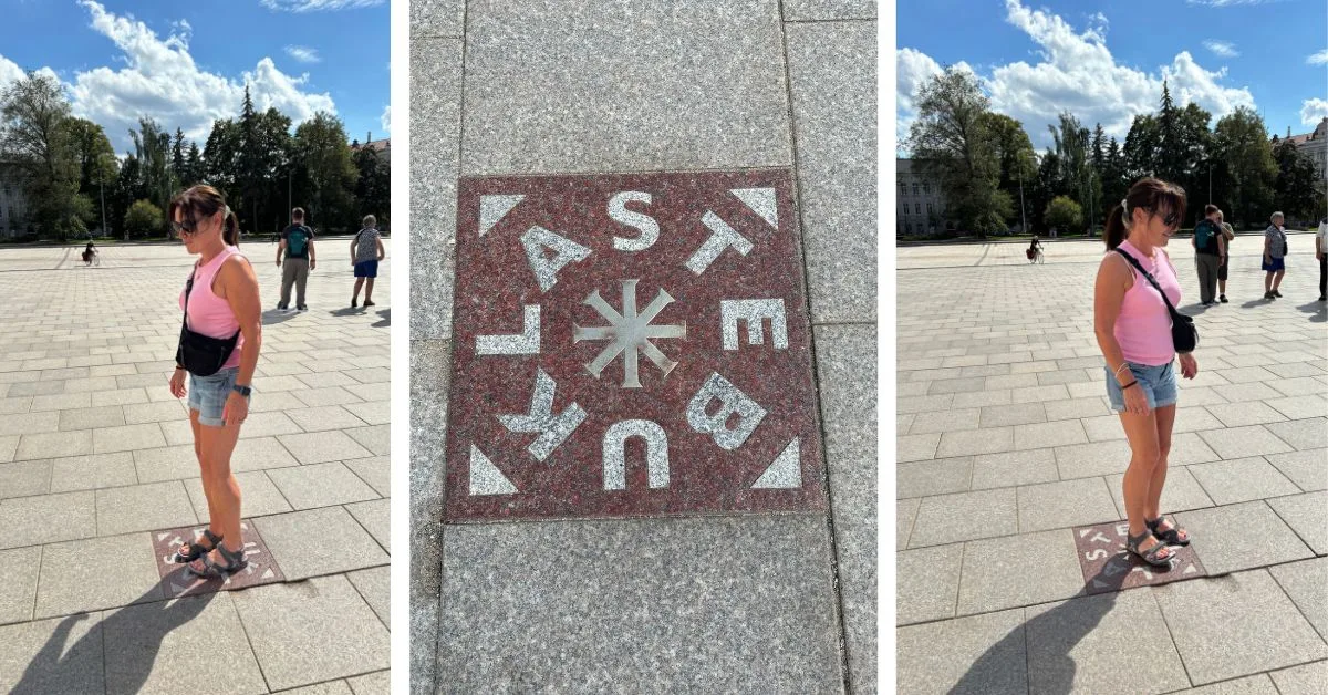 Woman standing on a magic square tile in Vilnius Cathedral Square and turning around on it