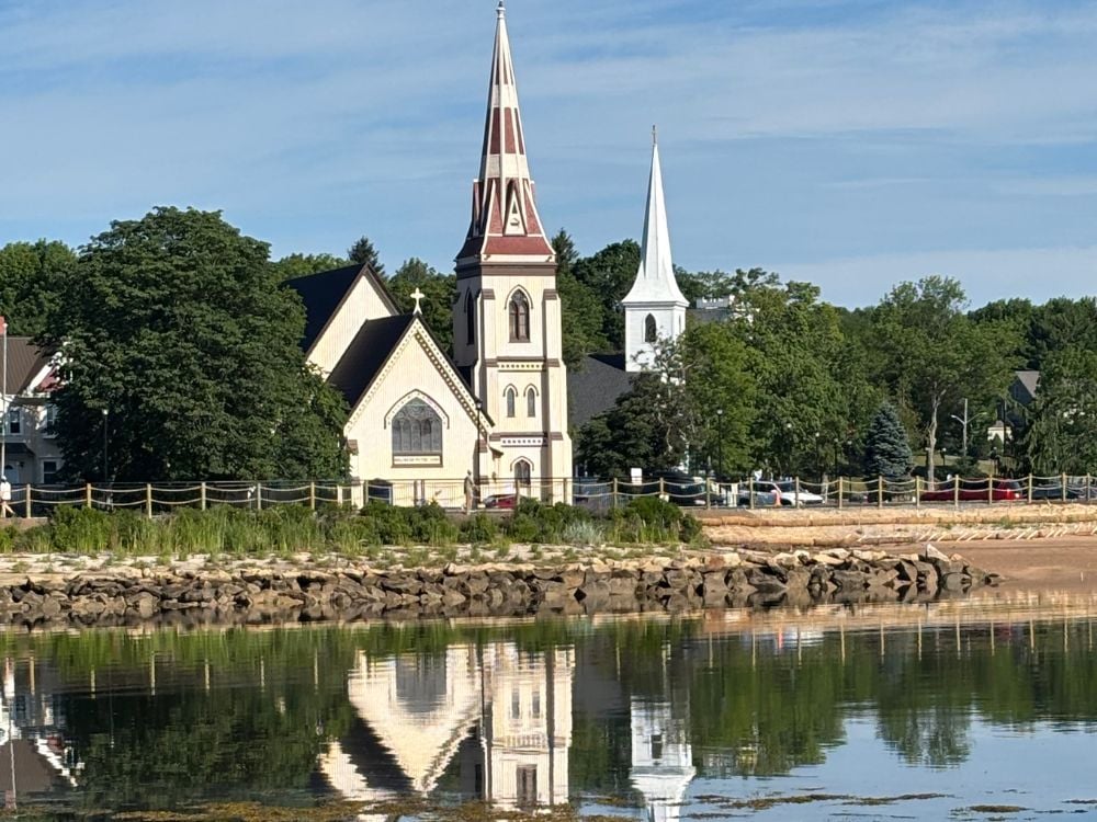 The Three Churches of Mahone Bay reflected in the bay