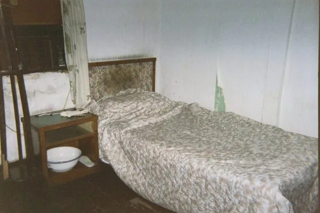 An example of a dirty hotel room with stained sheets.