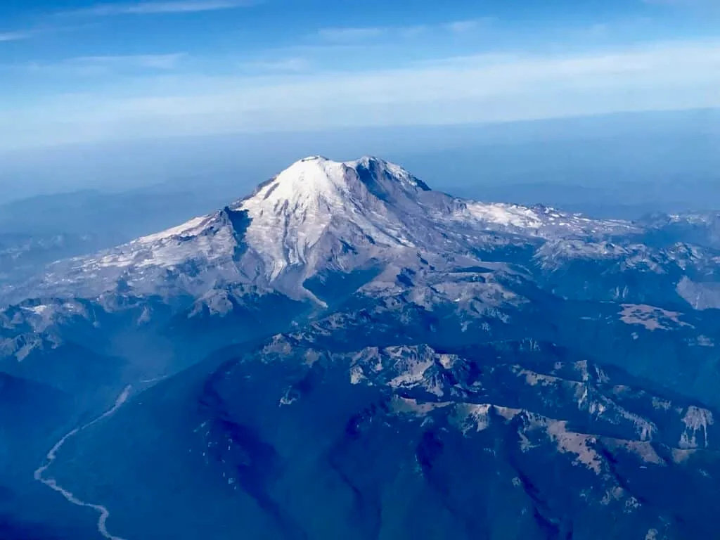 Snow capped peaks of Mount Rainier in Washington State, USA taken from an airplane window.
