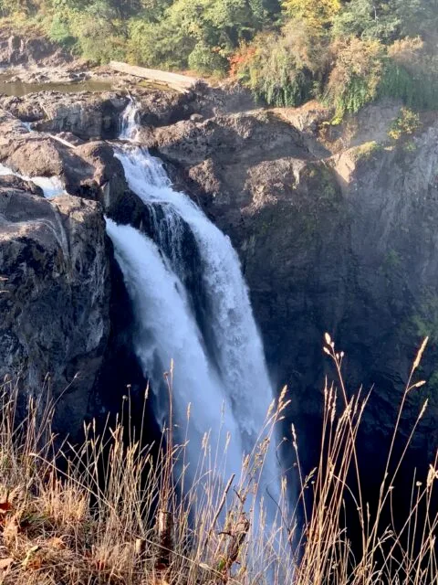 Two cascades of water rushing down a cliff edge