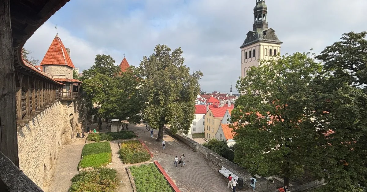 View looking down from city wall onto King's Gardens which has neat square grass bed and a terrace with views out to the old town.