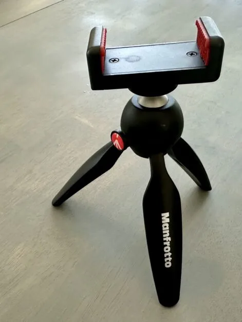 A mini tripod showing a phone attachment.