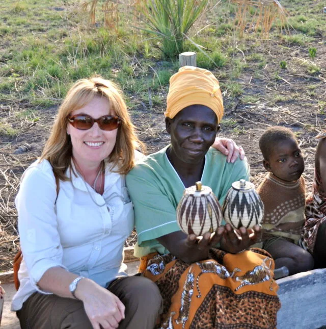 Tourist meeting a basket weaver in a village market.