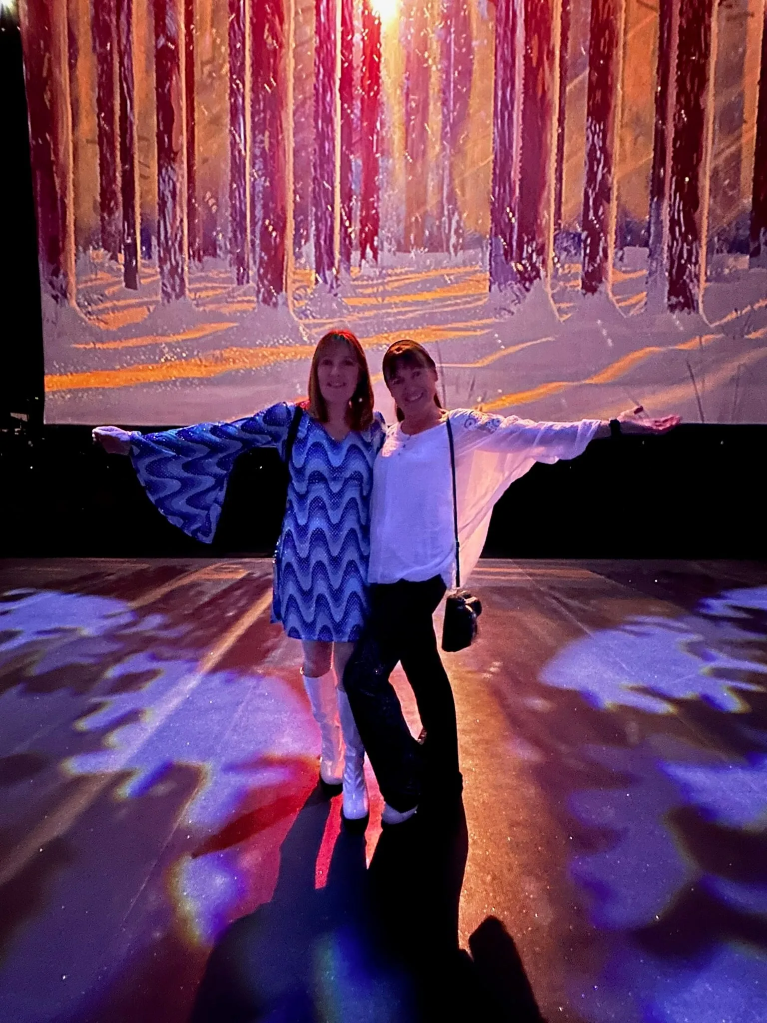 Two women at an interactive forest display