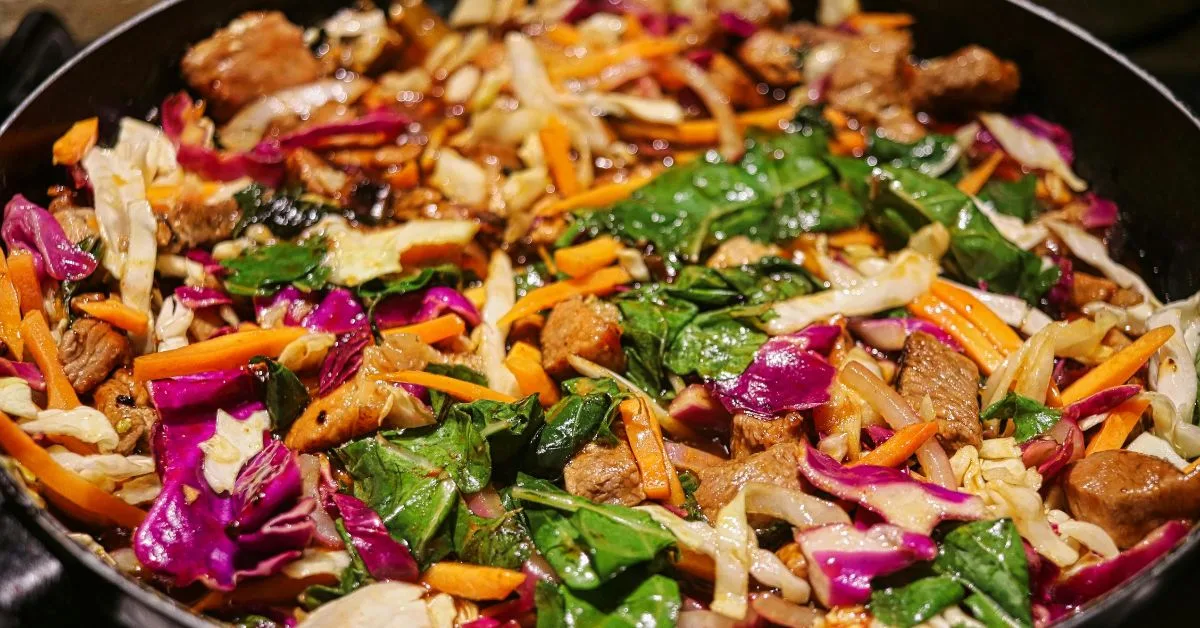 Multi colored Vegetables including carrots, spinach, potato and meat ready to eat.