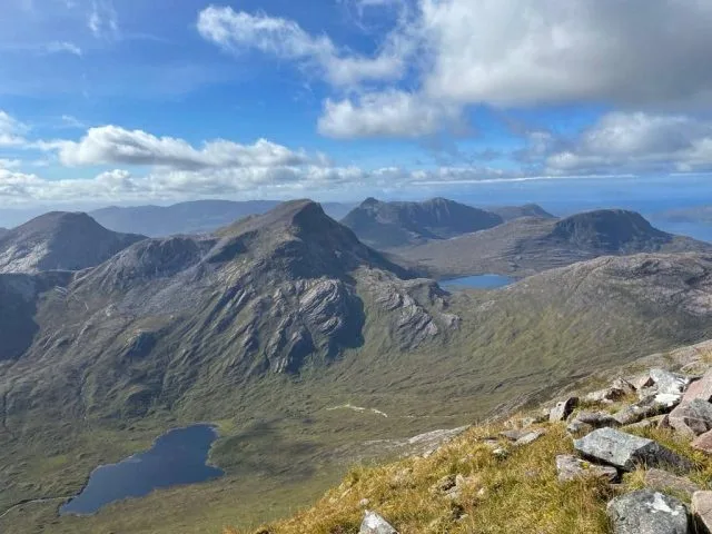 Highland mountains in Scotland with exposed stone peaks.