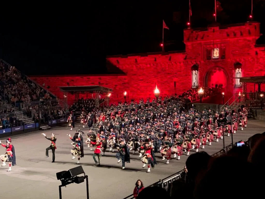 Bright red lighting shines down on pipers at Edinburgh Castle Show in Scotland.
