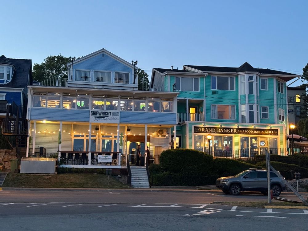 Waterfront restaurants lit up in the evening in Lunenburg