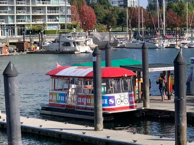 An Aguabus is parked at a jetty on Granville Island.