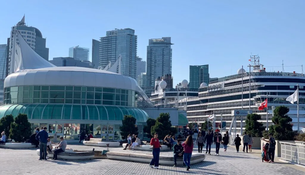A port in central Vancouver with a large cruise ship docked.