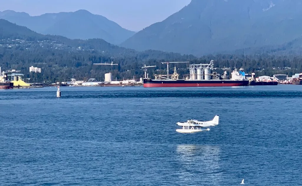 Float plane is landing in the bay waters of Vancouver Canada.