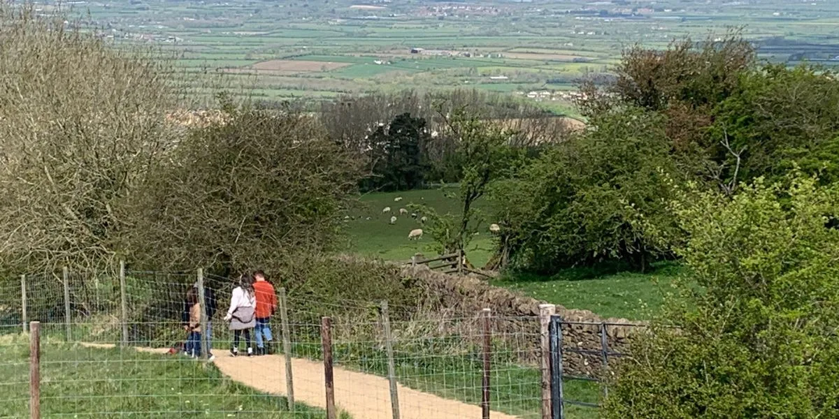 Family is strolling through a path within the towns and villages of the Cotswolds.