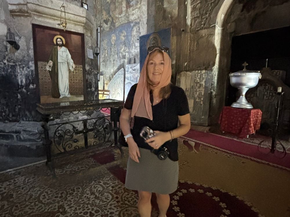 Woman inside a historic Armenian church dressed respectfully