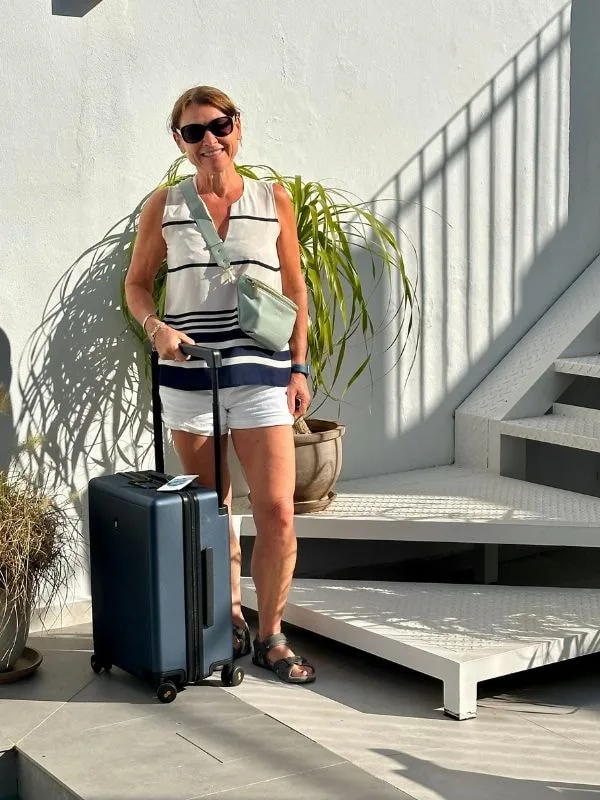 Woman traveller with stylish carry-on luggage