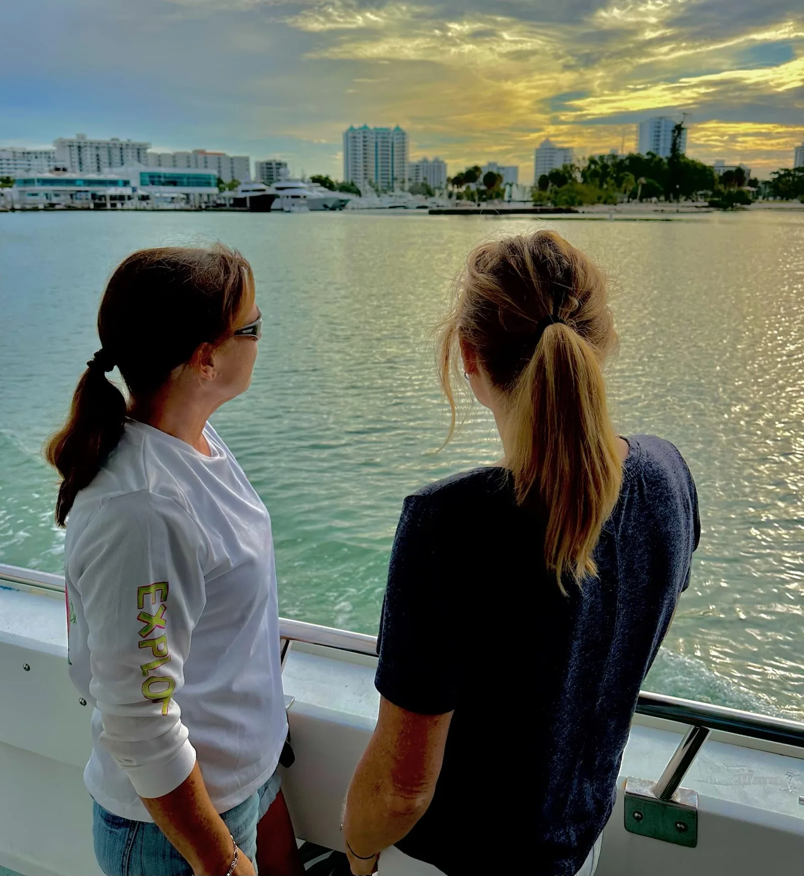 Women viewing a waterfront cityscape